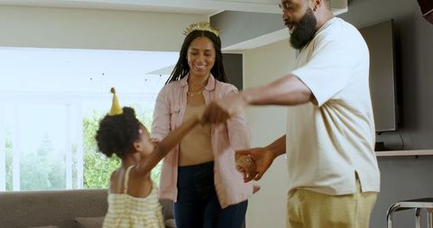 Smiling Family Celebrating Home Birthday with Joyful Dance