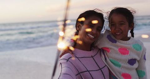 Mother and Daughter Celebrating with Sparklers on Sunset Beach - Download Free Stock Images Pikwizard.com
