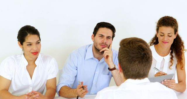 Group of business professionals interviewing a candidate. Perfect for topics on recruitment, job interviews, hiring processes, HR management, assessing job candidates, and business meetings.