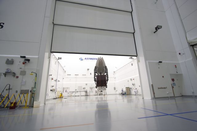 This image shows the TDRS-K satellite inside the Astrotech payload processing facility near Kennedy Space Center. The satellite is being inspected before encapsulation into a nose faring. Ideal for content about satellite technology, space exploration, or NASA missions.