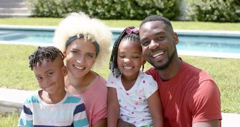 Happy Family Bonding Outdoors by Pool on Sunny Day