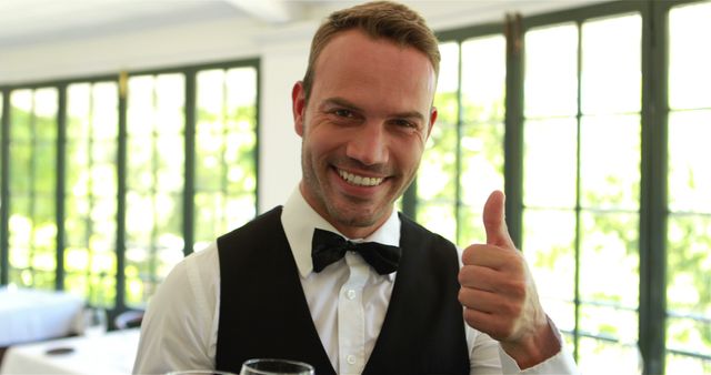 Smiling Waiter Giving Thumbs Up in Modern Restaurant Setting - Download Free Stock Images Pikwizard.com