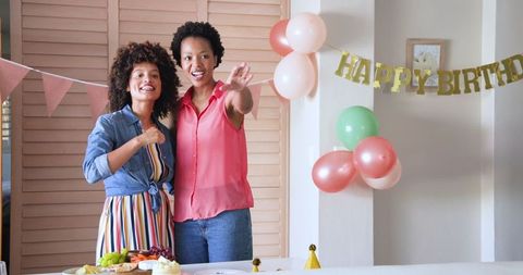 Joyful Diverse Female Couple Celebrating a Birthday at Home