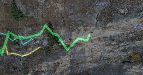 Climber following neon overlay on cliff path