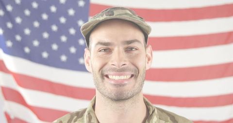 Smiling soldier in camouflage with american flag background
