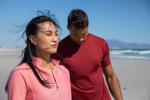 Couple Relaxing on Tranquil Beach at Sunrise