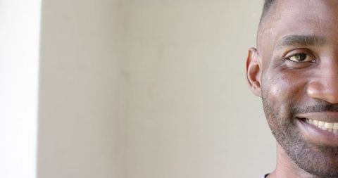 Closeup smiling adult male headshot with copy space neutral beige background