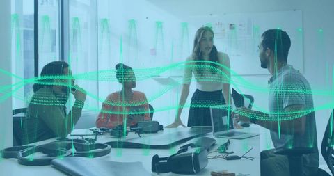 Team collaborating around table with VR headsets and holographic waveform overlay concept