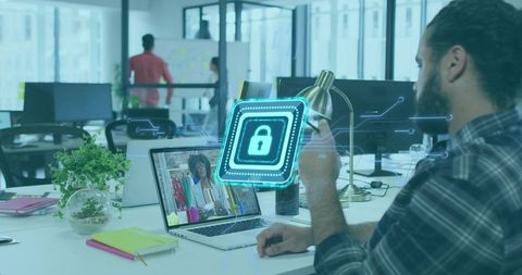 Man in office engaging in virtual meeting with futuristic security overlay