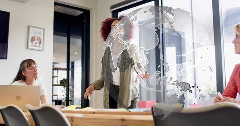 Female leader presenting global strategy to creative team in modern office