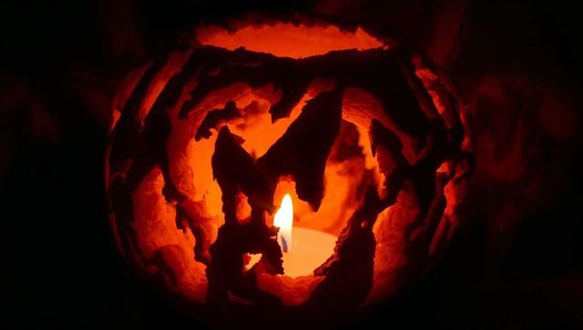 Glowing jack-o'-lantern with dramatic shadows at night