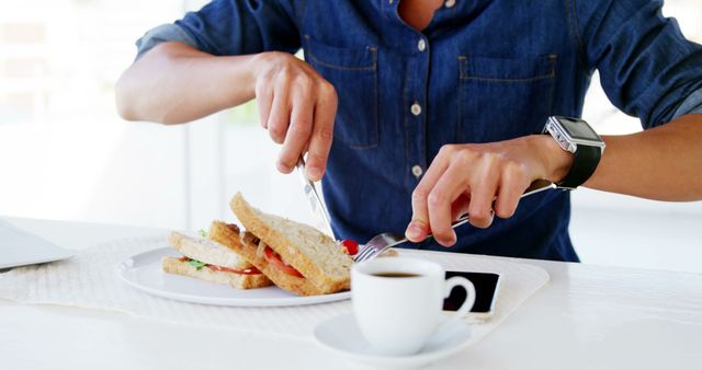 Man Eating Healthy Sandwich at Breakfast Table with Coffee - Download Free Stock Images Pikwizard.com