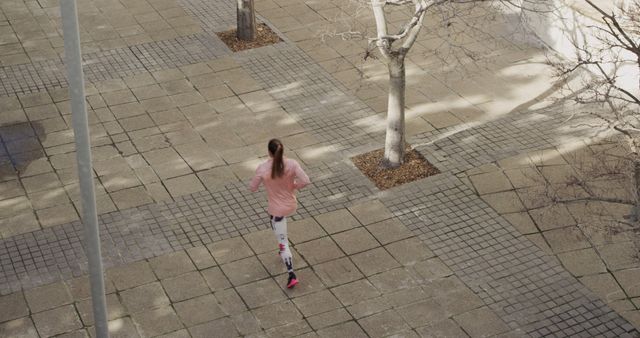 Woman Jogging on Paved Path in Urban Area - Download Free Stock Images Pikwizard.com