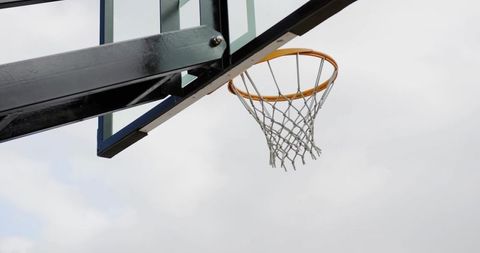 Outdoor Basketball Hoop Against Cloudy Sky