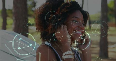 Smiling woman in nature with holographic music icons