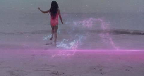 Girl walking on twilight beach leaving footprints with pink nebula overlay, dreamy horizon
