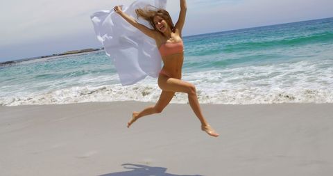Joyful Woman Running on Beach with Sarong - Download Free Stock Images Pikwizard.com
