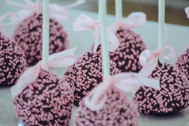Close-Up of Chocolate Cake Pops with Pink Sprinkles and Ribbons - Download Free Stock Photos Pikwizard.com