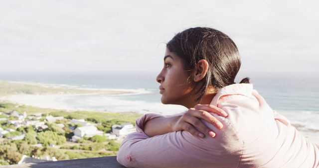 Image of thoughtful biracial woman by sea looking into distance - Download Free Stock Photos Pikwizard.com