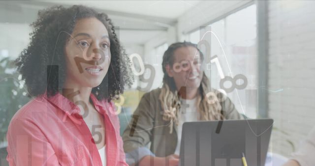 Two Business Professionals Analyzing Financial Data on Laptop - Download Free Stock Images Pikwizard.com