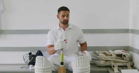 Cricket Player Focused in Locker Room Preparing for Match - Download Free Stock Images Pikwizard.com