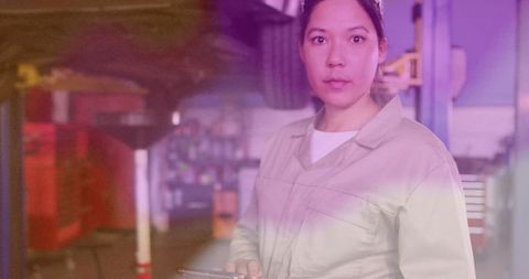 Female Mechanic in Workshop Utilizing Digital Tablet Technology