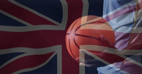 Biracial male holding basketball overlaid with uk flag