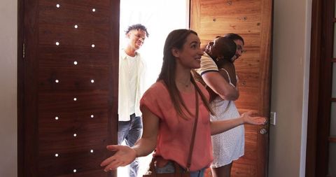 Welcoming friends at home entrance for gathering