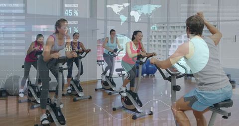 Group Spinning Class Following Male Instructor with Digital HUD Fitness Analytics Overlay