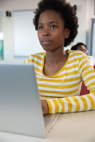 Focused Young Student Engaged in Study at School Desk