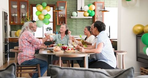 Joyful Seniors Enjoying Dinner Party in Cozy Home Setting