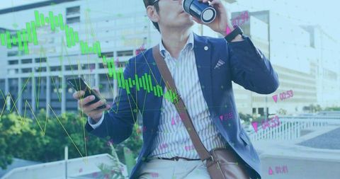 Professional checking smartphone while drinking coffee on urban terrace with financial charts