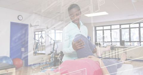 Female clinician supporting patient during knee rehab on treatment table with hud overlay
