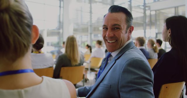 Smiling Businessman Attending Conference with Colleagues - Download Free Stock Images Pikwizard.com