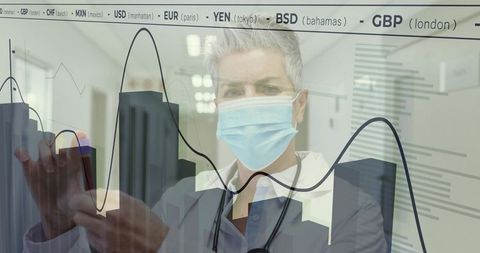 Doctor with Mask Analyzing Data on Transparent Screen in Hospital