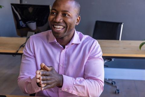 Professional Black Man Engaging in Office Discussion