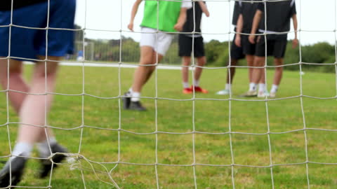 Youth Soccer Team Practicing Dribbling Skills on Field