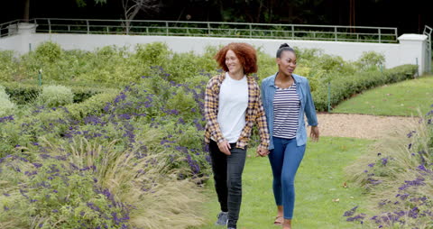 Diverse Couple Enjoying a Stroll Through Lush Garden