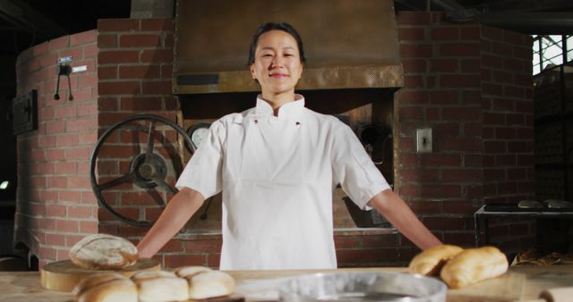 Proud Artisan Baker Displaying Freshly Baked Bread in Rustic Bakery - Download Free Stock Images Pikwizard.com