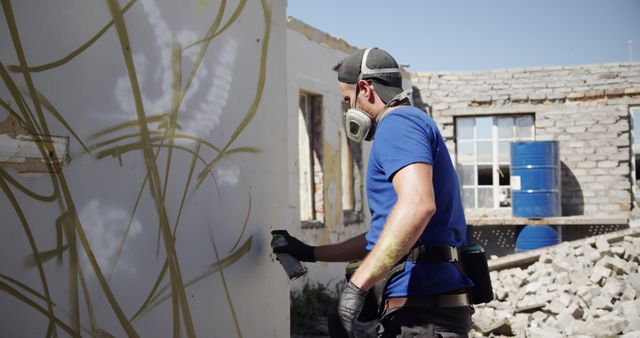 Construction Worker Spraying Graffiti on Wall at Rebuild Site - Download Free Stock Images Pikwizard.com