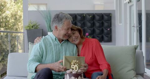 Senior Couple Celebrating 50th Anniversary with Joyful Embrace