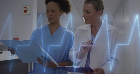 Healthcare professionals discussing medical data with heartbeat overlay