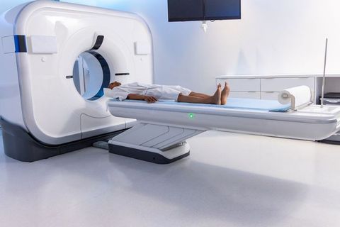 African american man undergoing ct scan on advanced scanner in clinical radiology room