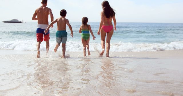 This image shows a family running towards the waves on a sunny beach. Ideal for travel and vacation advertising, family-oriented websites, or summer activity promotions.