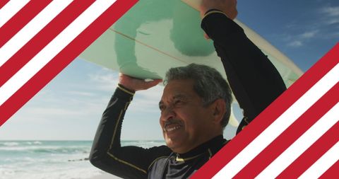 Senior Man with Surfboard on Beach with American Theme