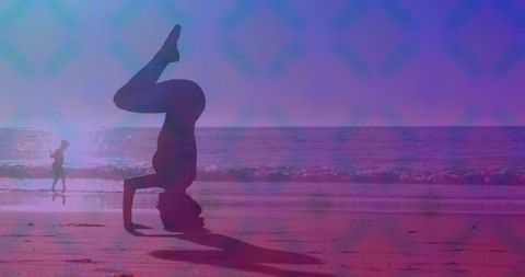 Silhouette Practicing Headstand on Beach During Sunset