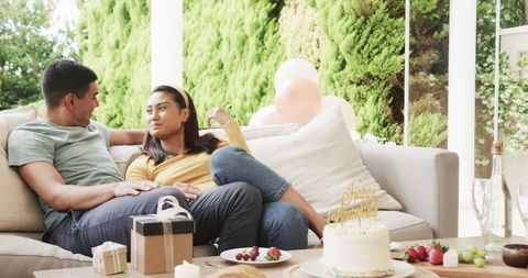 Couple Relaxing with Snacks Celebrating with Cake in Outdoor Setting
