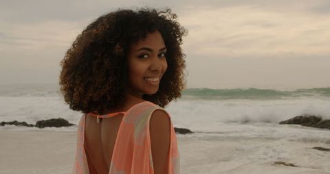Woman Enjoying Beachfront with Waves in Background