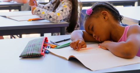 Tired Schoolgirl Sleeping on Desk During Lesson - Download Free Stock Images Pikwizard.com