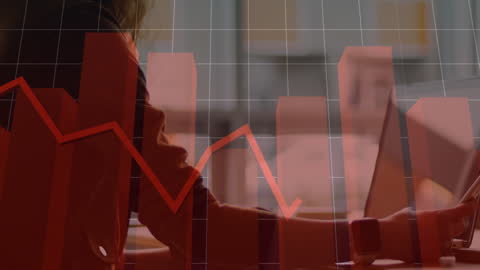 Business Executive Analyzing Economic Data on Laptop and Phone